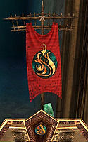 Red Luxon banner with a gold and green emblem in the Guild Wars 1 Hall of Monuments
